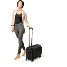 Load image into Gallery viewer, Briggs &amp; Riley Baseline Wide Carry On Wheeled Garment Spinner - lifestyle wheeling
